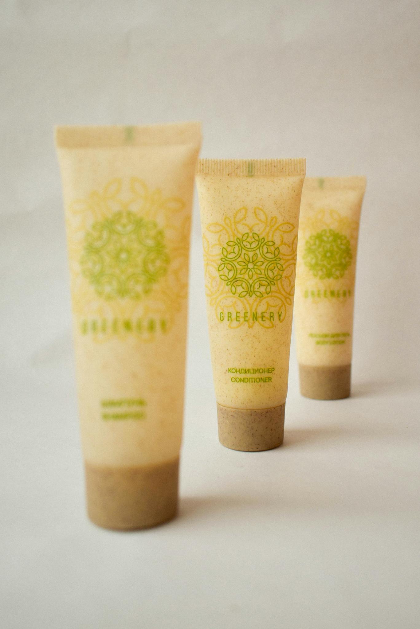 Eco-friendly skincare tubes arranged artfully on a beige backdrop.