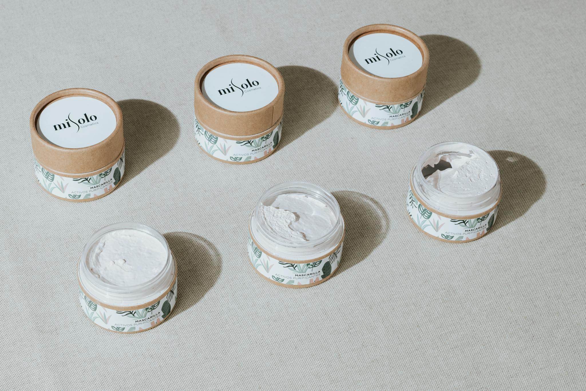 Top view of natural skincare creams in eco-friendly packaging, promoting sustainability and beauty.